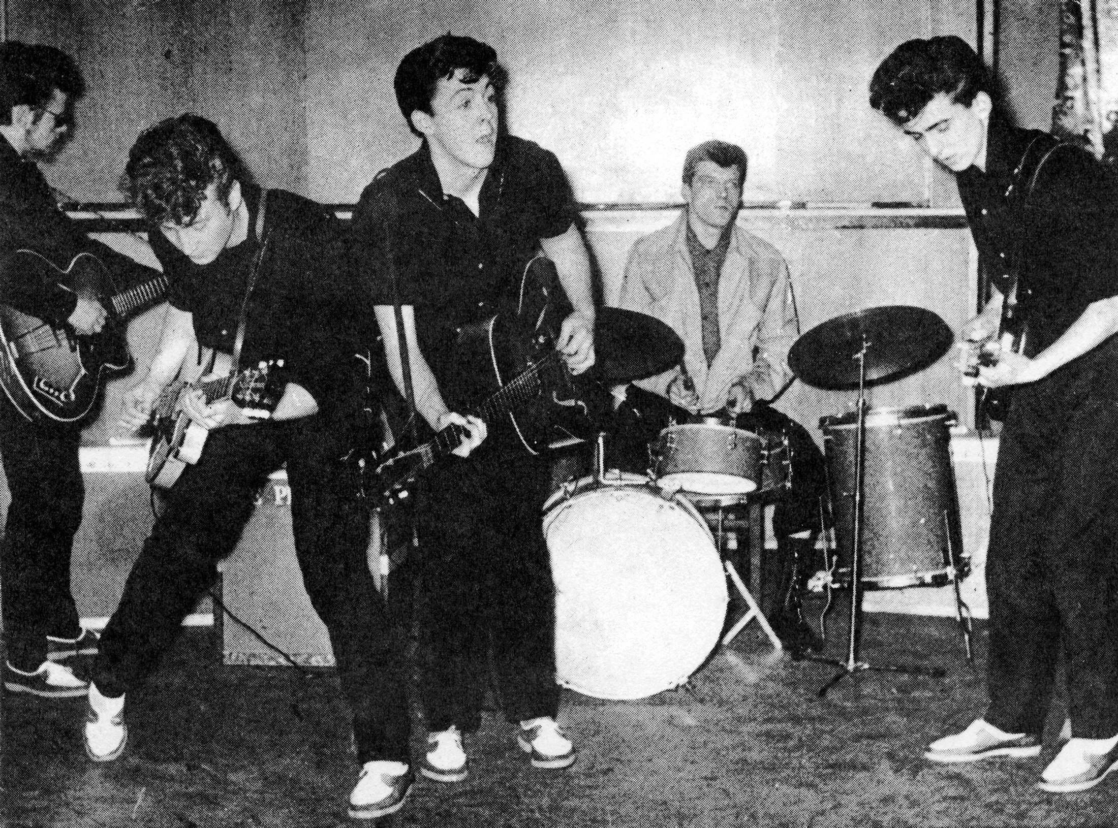 The pre-Beatles group the Silver Beetles onstage in Liverpool, England, 1960. (left to right: Stu Sutcliffe, John Lennon, Paul McCartney, Johnny Hutch, and George Harrison). Photo via Michael Ochs Archive/Getty Images.